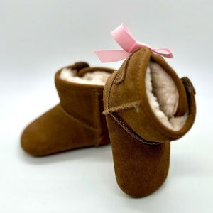 UGG® Jesse booties with pink bow detail.